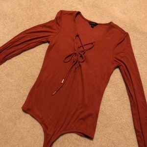 Burnt orange, extra small bodysuit never worn
